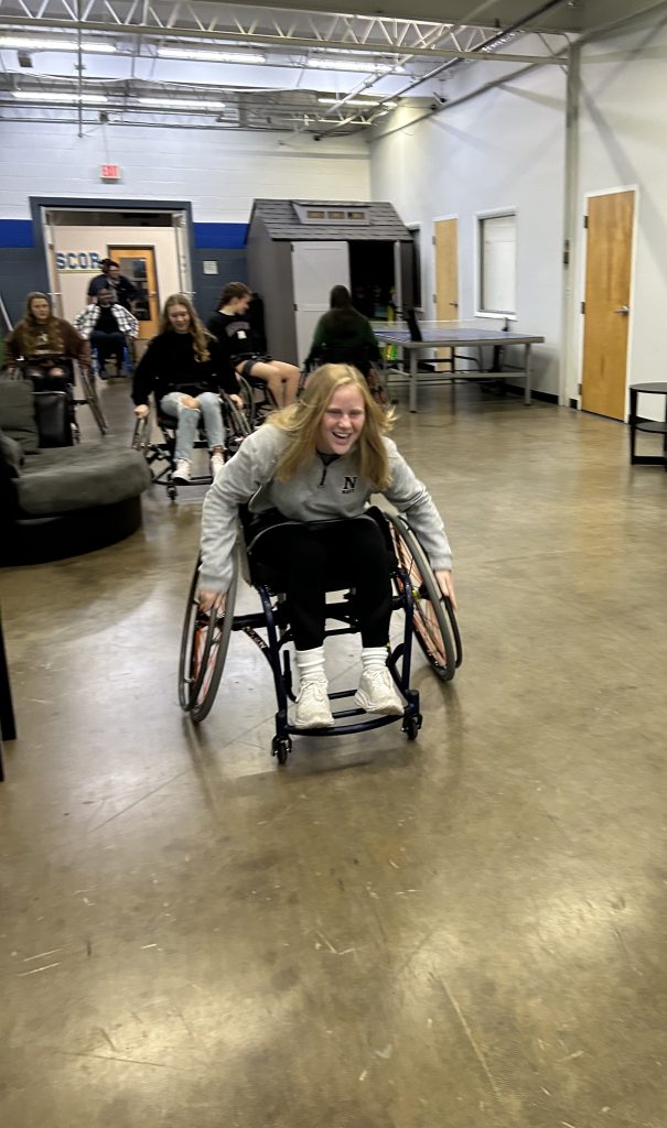 Charlotte Smith tries out an adaptive sports chair.